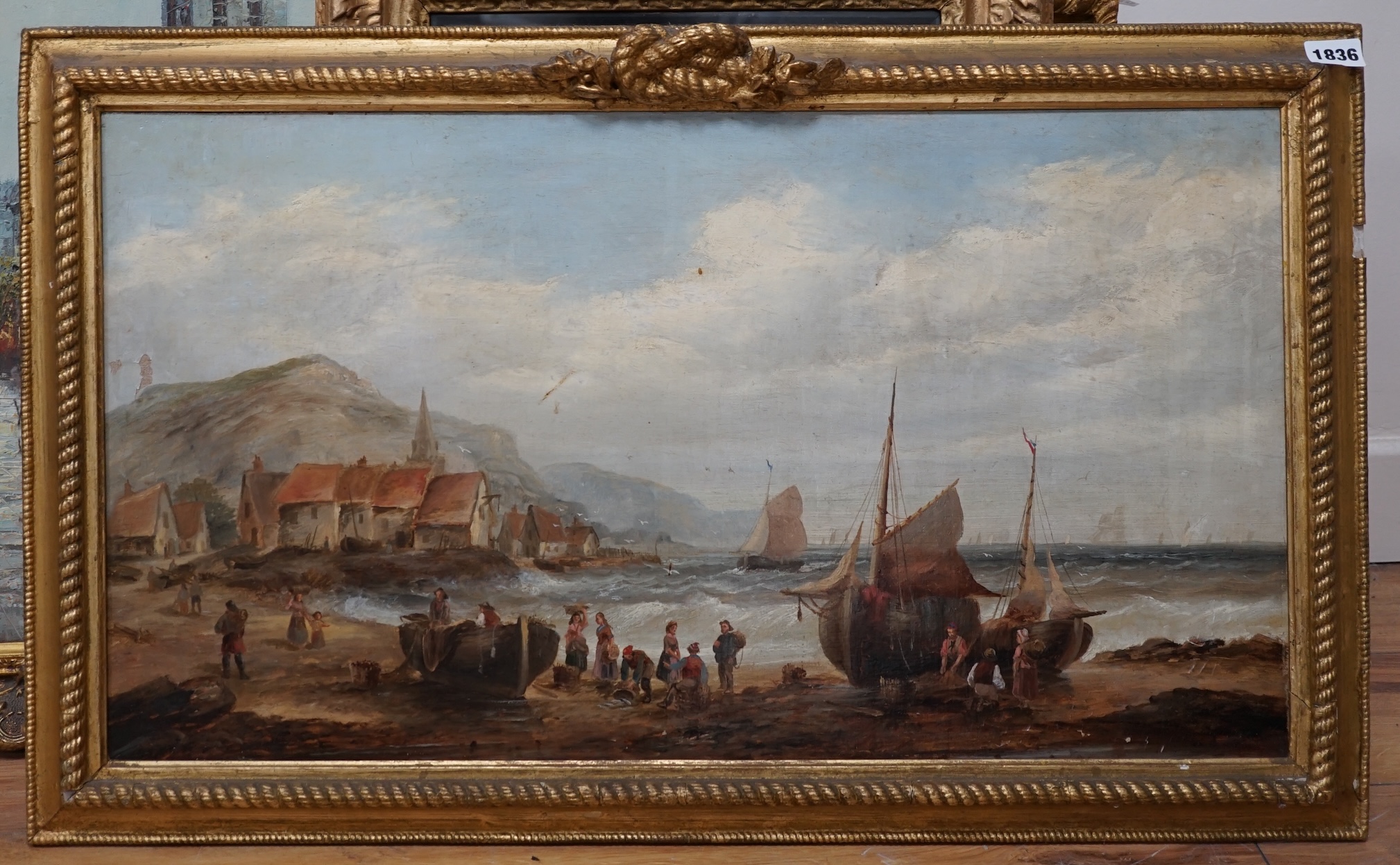 British School, 19th century, oil on canvas, Beach scene with figures, fishing boats, village and hills beyond, 37 x 67cm. Condition - fair, some losses to the paint